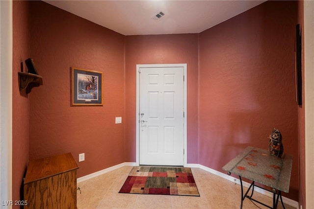 entrance foyer with tile patterned flooring and baseboards