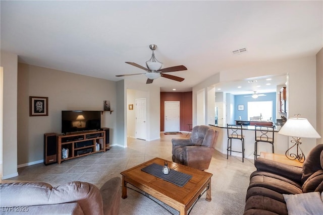 living area with ceiling fan, baseboards, tile patterned flooring, and recessed lighting
