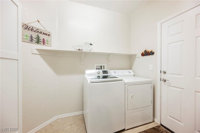 washroom with independent washer and dryer, baseboards, and light tile patterned floors