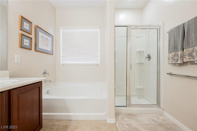 bathroom with vanity, a stall shower, a bath, and tile patterned floors