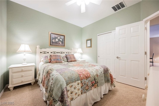 bedroom featuring light colored carpet, a closet, a ceiling fan, and baseboards