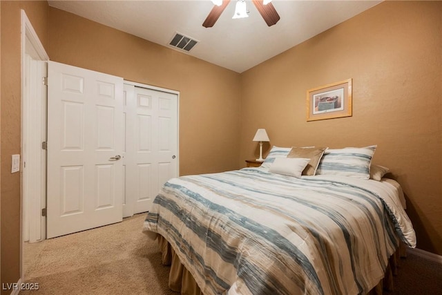 carpeted bedroom featuring ceiling fan and a closet