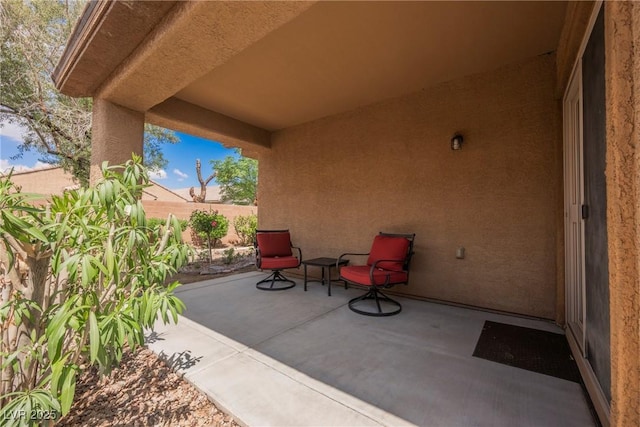 view of patio featuring fence