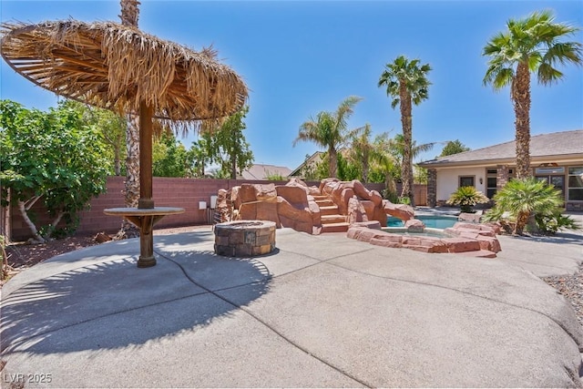 6224 Red Pine Ct, Las Vegas, NV 89130 - view of patio / terrace featuring an outdoor fire pit and an in-ground hot tub