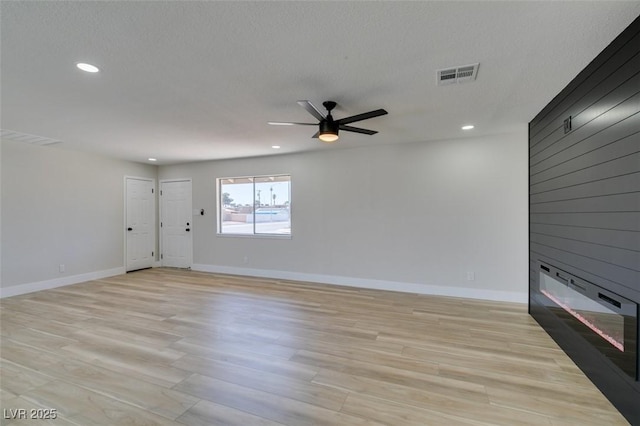 unfurnished living room featuring recessed lighting, a fireplace, ceiling fan, and baseboards