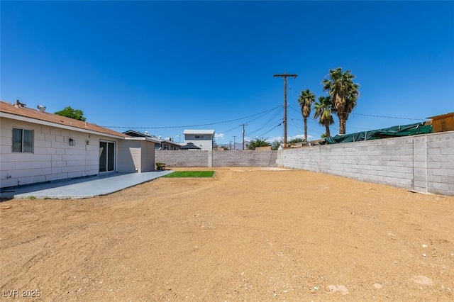 fenced backyard with a patio