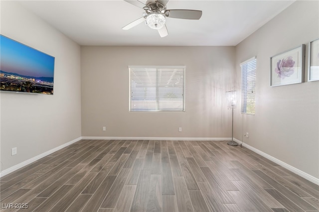 empty room featuring wood finished floors, a ceiling fan, and baseboards
