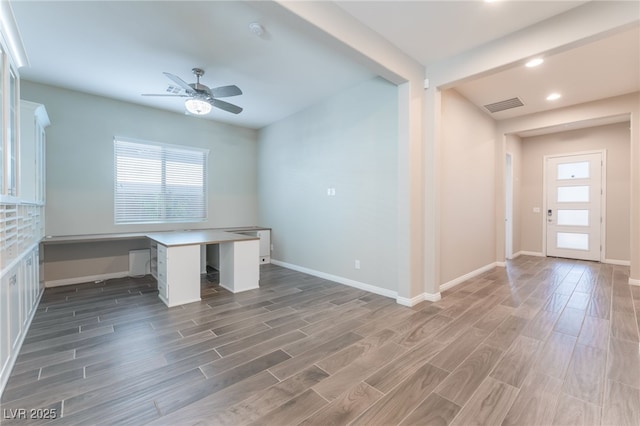 unfurnished office with plenty of natural light, wood finished floors, a ceiling fan, and recessed lighting