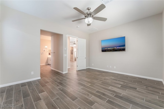 unfurnished bedroom with wood finished floors, baseboards, and a ceiling fan