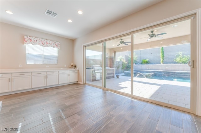 entryway with light wood-style floors, recessed lighting, and a ceiling fan