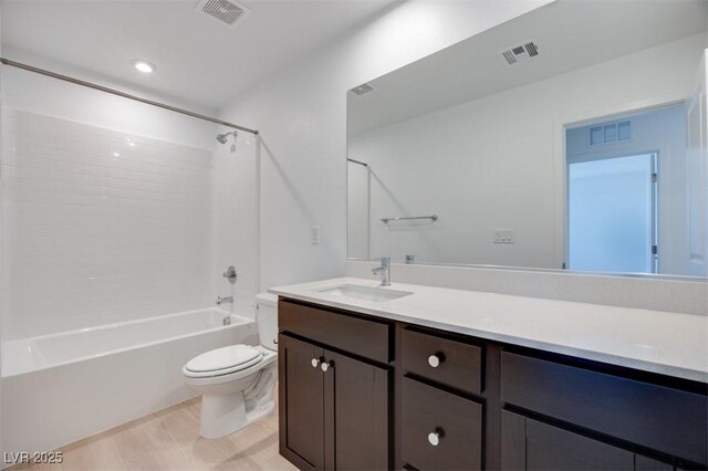 bathroom featuring toilet, vanity, and shower / bath combination
