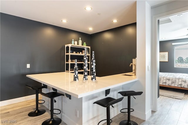 3458 W Agate Ave, Las Vegas, NV 89139 - bar with light wood-type flooring, recessed lighting, and baseboards