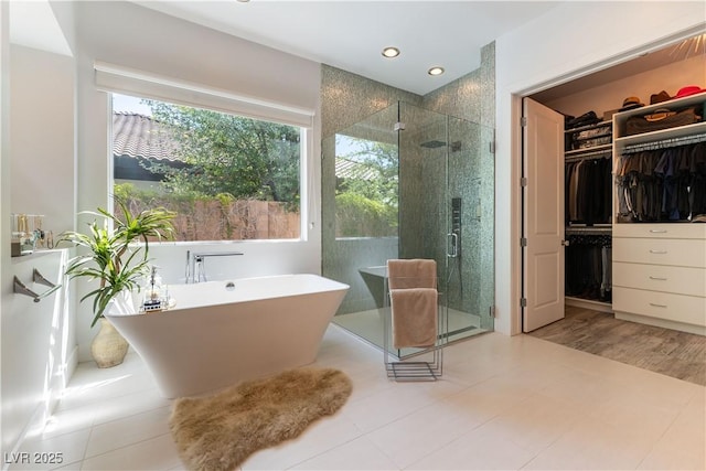 3458 W Agate Ave, Las Vegas, NV 89139 - bathroom featuring a walk in closet, a stall shower, a freestanding tub, and recessed lighting