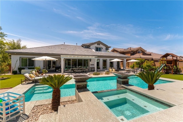 3458 W Agate Ave, Las Vegas, NV 89139 - back of house with a patio area, a playground, a pool with connected hot tub, and an outdoor hangout area