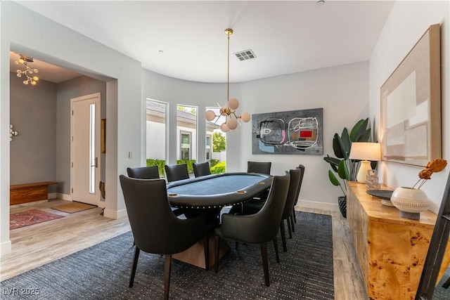3458 W Agate Ave, Las Vegas, NV 89139 - dining space with a chandelier, wood finished floors, and baseboards