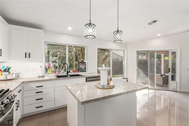 286 Fairmeadow St, Henderson, NV 89012 - kitchen with a sink, stainless steel gas range, light stone countertops, plenty of natural light, and recessed lighting