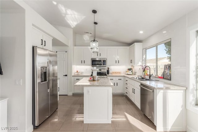 286 Fairmeadow St, Henderson, NV 89012 - kitchen with appliances with stainless steel finishes, a sink, a center island, vaulted ceiling, and white cabinets