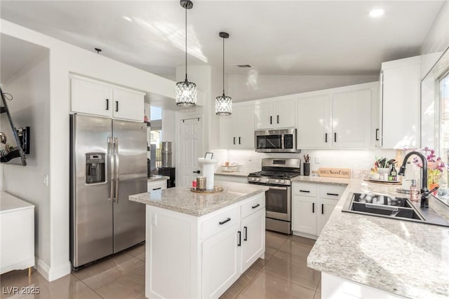 286 Fairmeadow St, Henderson, NV 89012 - kitchen with appliances with stainless steel finishes, a sink, vaulted ceiling, decorative backsplash, and a center island