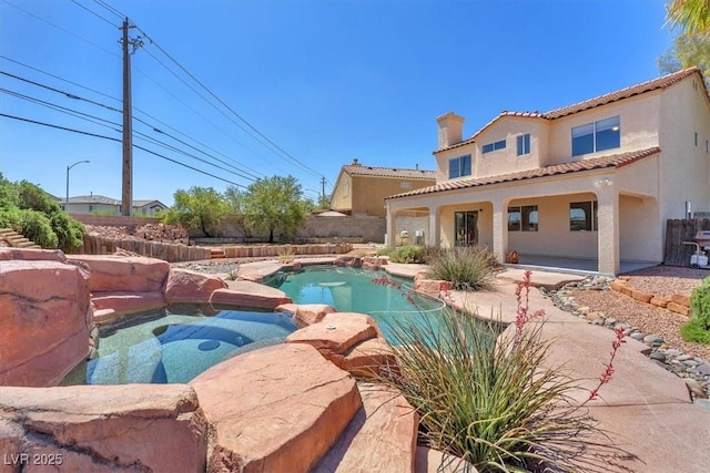 view of swimming pool with a fenced backyard, a patio, and a pool with connected hot tub