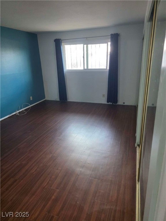 empty room with dark wood-type flooring