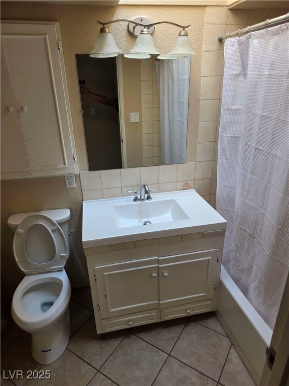 bathroom featuring tile patterned flooring, vanity, and toilet
