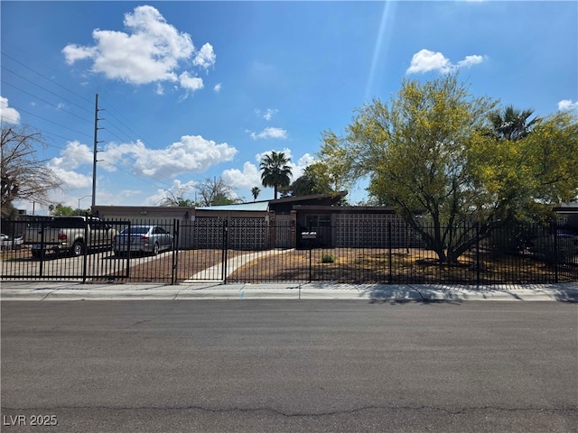 view of front of home with a fenced front yard and a gate