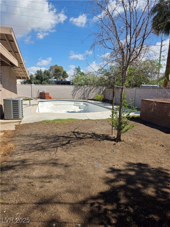 fenced backyard with central AC and a patio area
