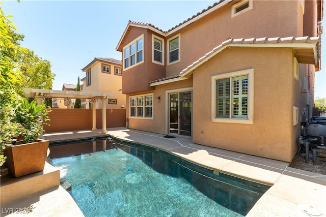 11228 Hedgemont Ave, Las Vegas, NV 89138 - rear view of house featuring stucco siding, an outdoor pool, fence, a tiled roof, and a patio