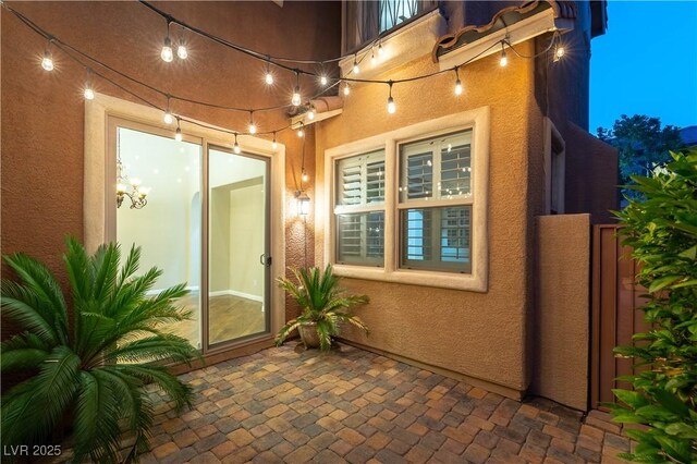 11228 Hedgemont Ave, Las Vegas, NV 89138 - view of exterior entry with stucco siding and a patio