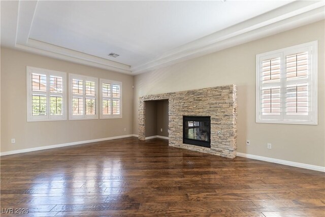 11228 Hedgemont Ave, Las Vegas, NV 89138 - unfurnished living room with dark wood finished floors, a stone fireplace, and baseboards