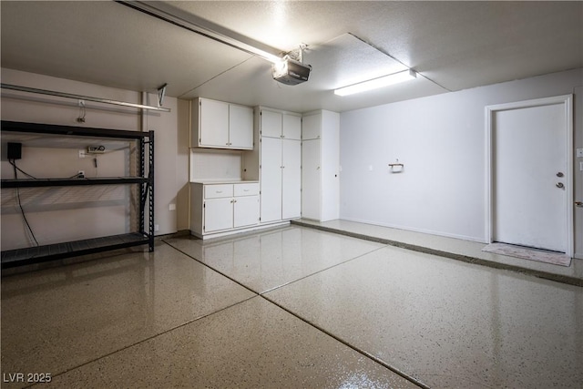 10336 Birch Bluff Ln, Las Vegas, NV 89145 - garage with baseboards and a garage door opener