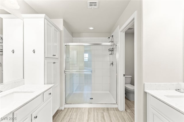 160 Lomita Heights Dr, Las Vegas, NV 89138 - bathroom with two vanities, a shower stall, and recessed lighting