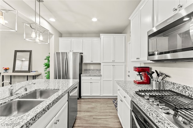 160 Lomita Heights Dr, Las Vegas, NV 89138 - kitchen featuring stainless steel appliances, white cabinetry, recessed lighting, light wood-type flooring, and pendant lighting