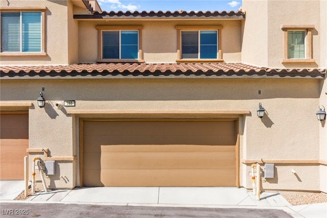 160 Lomita Heights Dr, Las Vegas, NV 89138 - view of front of house with a garage, a tile roof, and stucco siding