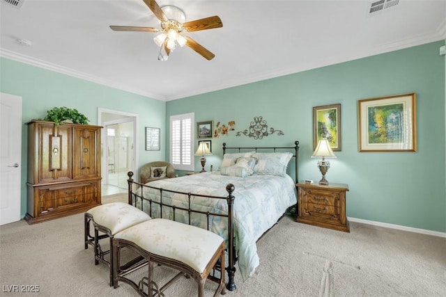 bedroom with light colored carpet, ornamental molding, baseboards, a ceiling fan, and ensuite bath