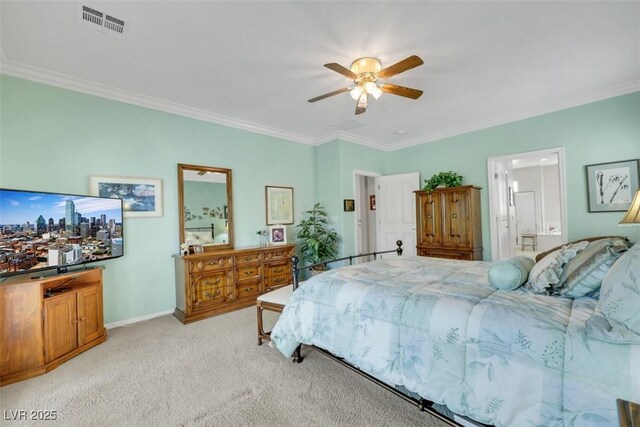 bedroom featuring crown molding, light colored carpet, a ceiling fan, ensuite bathroom, and baseboards