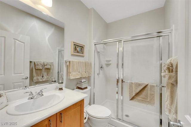 full bathroom with toilet, a shower stall, and vanity