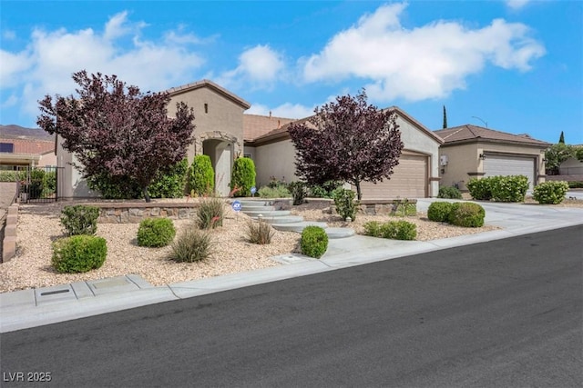 view of front facade featuring an attached garage, stucco siding, and driveway