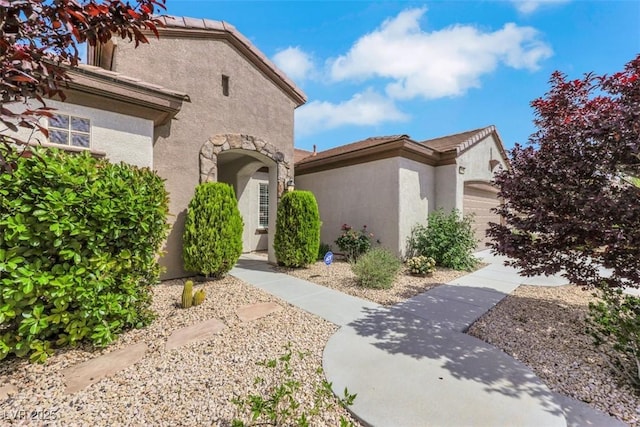 view of front facade featuring stucco siding and an attached garage