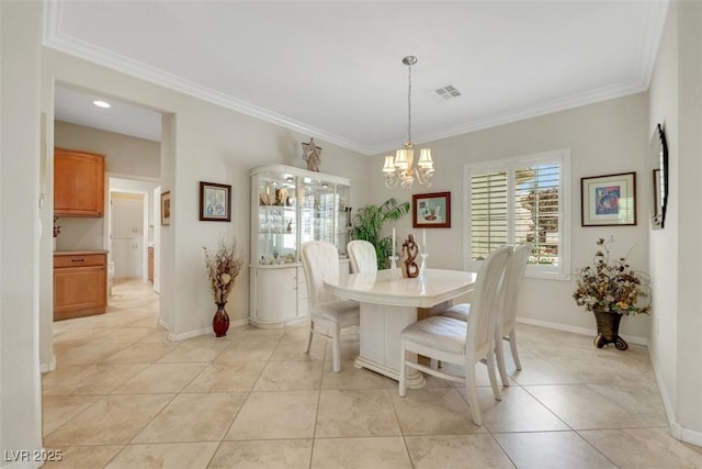 dining room with crown molding, a chandelier, light tile patterned flooring, and baseboards