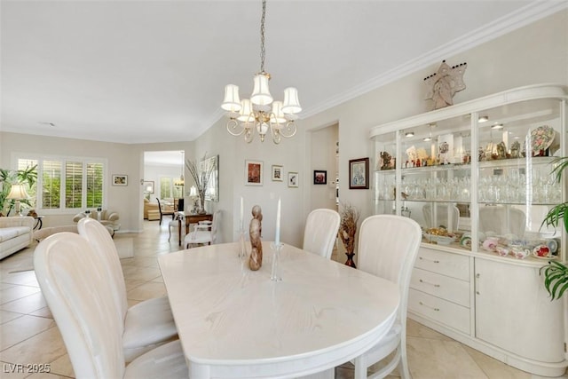 dining space with a chandelier, light tile patterned floors, and crown molding