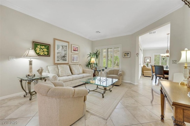 living area featuring crown molding, healthy amount of natural light, baseboards, and a chandelier