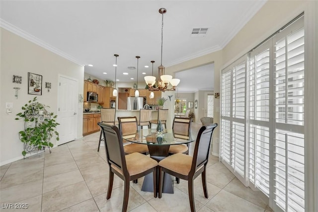 dining space featuring ornamental molding, a chandelier, light tile patterned floors, and baseboards