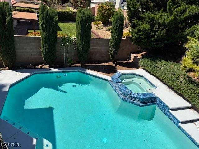view of swimming pool featuring a pool with connected hot tub