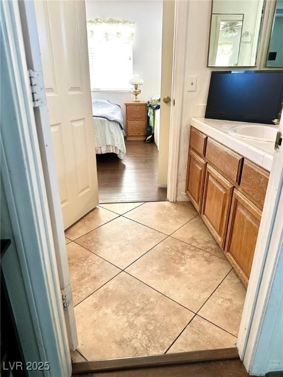 bathroom with tile patterned flooring, vanity, and ensuite bath