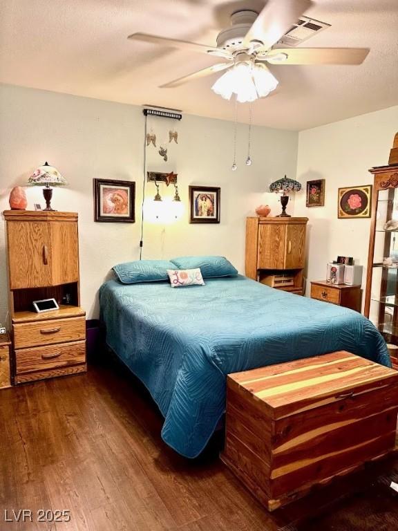 bedroom with wood finished floors and ceiling fan