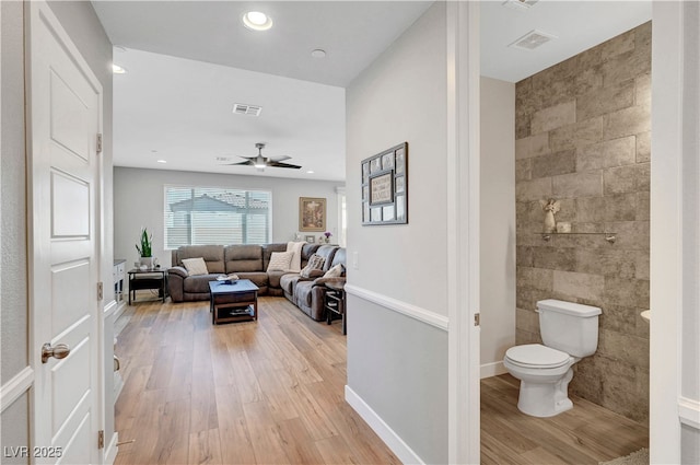 8958 Howell St, Las Vegas, NV 89166 - hall with light wood-type flooring, tile walls, recessed lighting, and baseboards