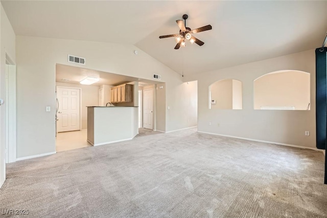unfurnished living room featuring ceiling fan, light carpet, baseboards, and high vaulted ceiling