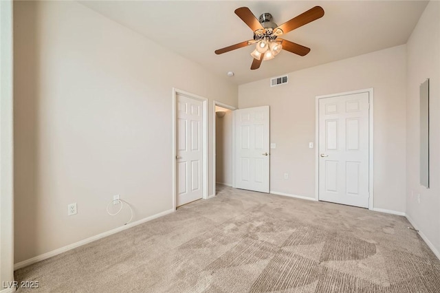 unfurnished bedroom featuring light colored carpet, baseboards, and a ceiling fan