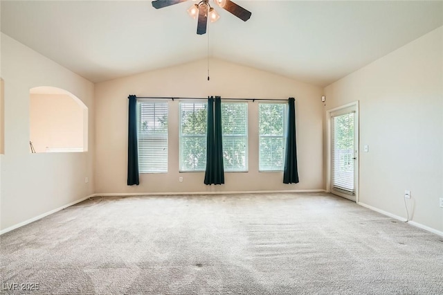unfurnished room with a ceiling fan, carpet, lofted ceiling, and baseboards
